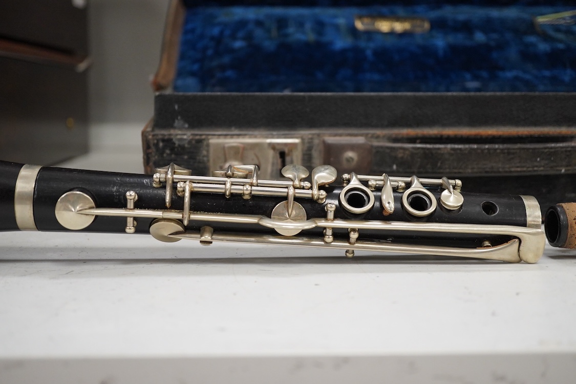An early 20th century wooden Boosey and Hawkes clarinet in a fitted leather case